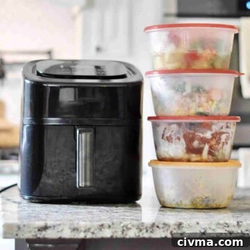 air fryer and several frozen meals in containers on a counter.