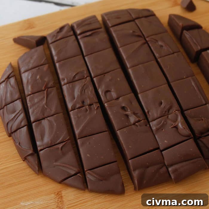 3 minute fudge a round slab of three minute fudge cut into squares on a wooden board.