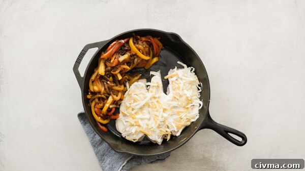 Chicken Fajita Casserole -- easy weeknight recipe with fajita veggies, black beans, sour cream and cheese on chicken breasts & baked in a cast iron skillet.