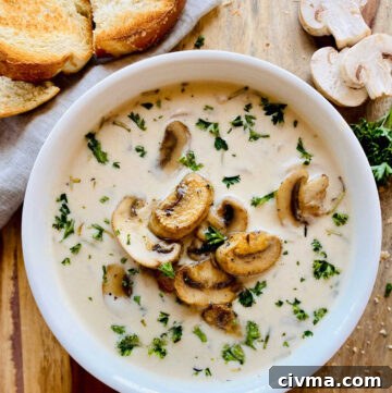 healthy mushroom soup in white bowl next to crusty bread