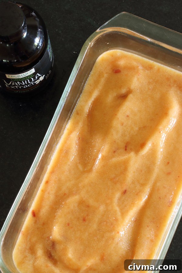 Peach sorbet in a glass loaf pan ready for the freezer