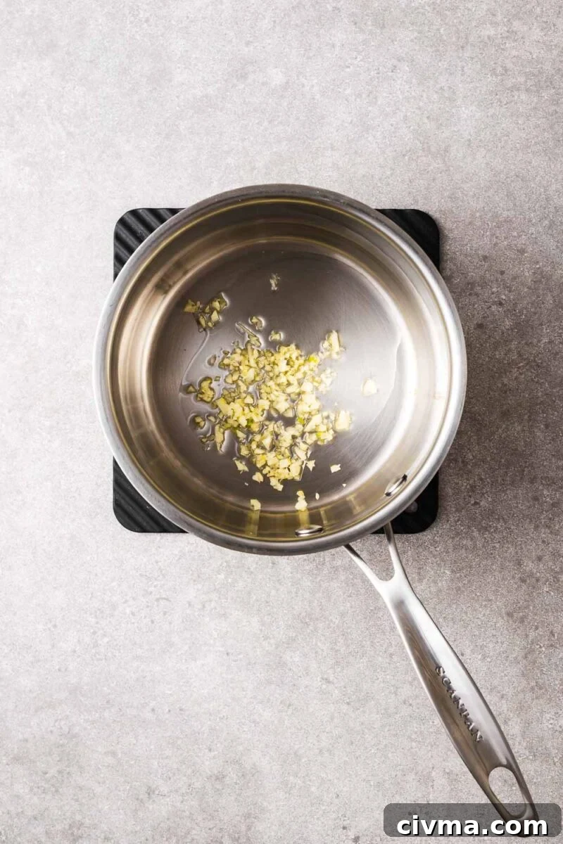 Uncooked garlic in cooking oil.