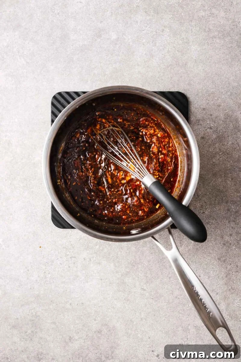 Mixing hoisin dipping sauce over medium heat.