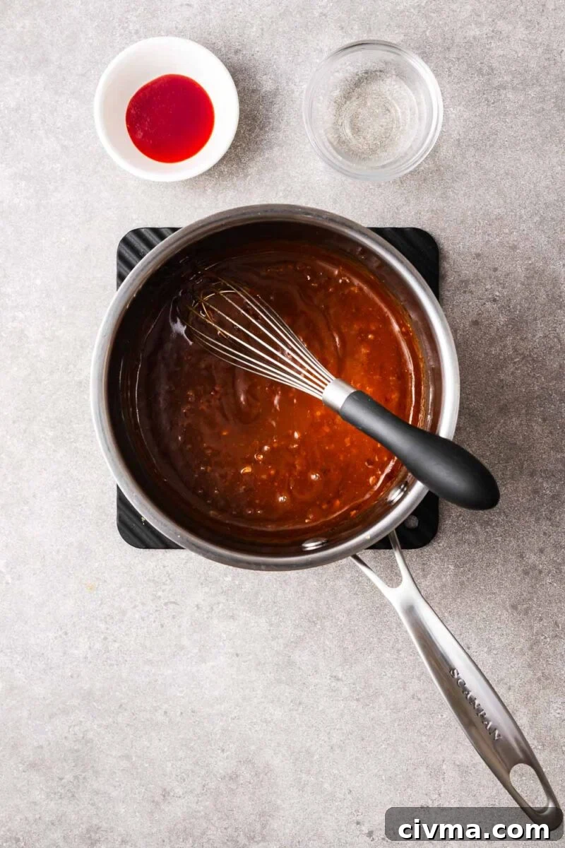 Whisking hoisin peanut sauce until it is well combined with a thick texture.