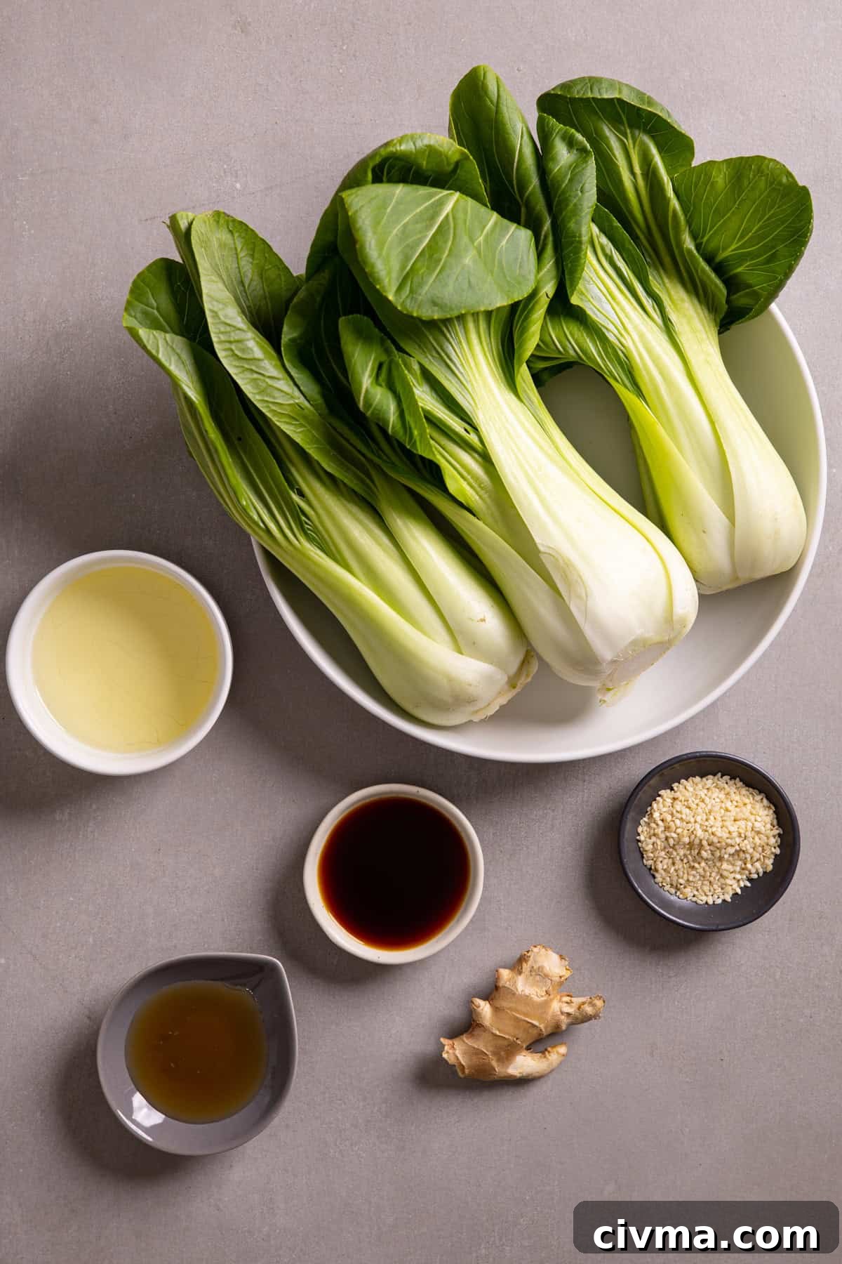 Roasted Bok Choy Recipe with Garlic and Sesame 3 Ingredients for roasted baby bok choy on a gray table.