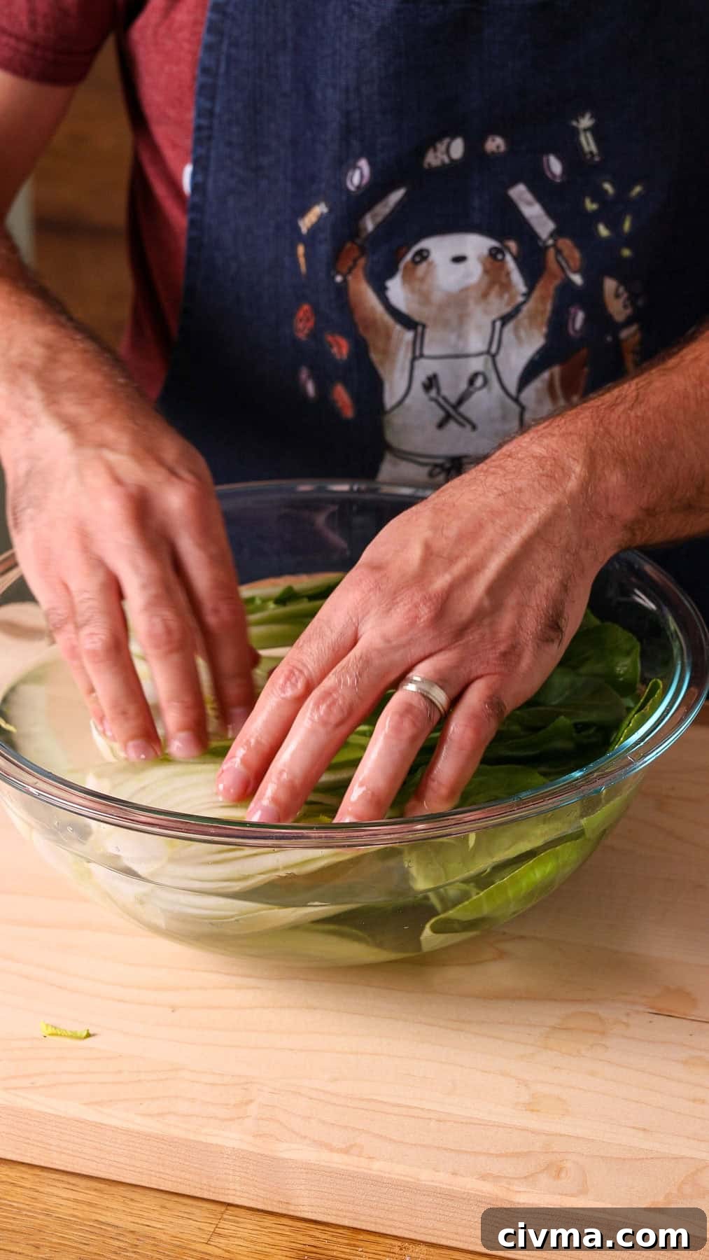 Roasted Bok Choy Recipe with Garlic and Sesame 8 Baby bok choy halves getting washed in a bowl of water.