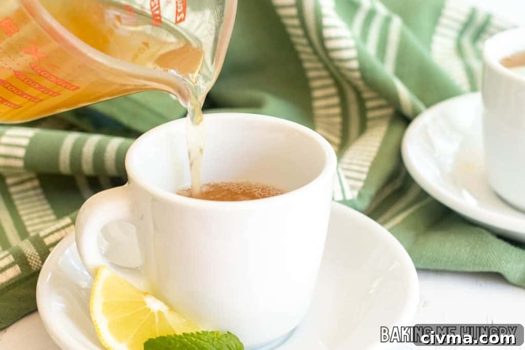 honey citrus mint tea recipe being poured into tea cup