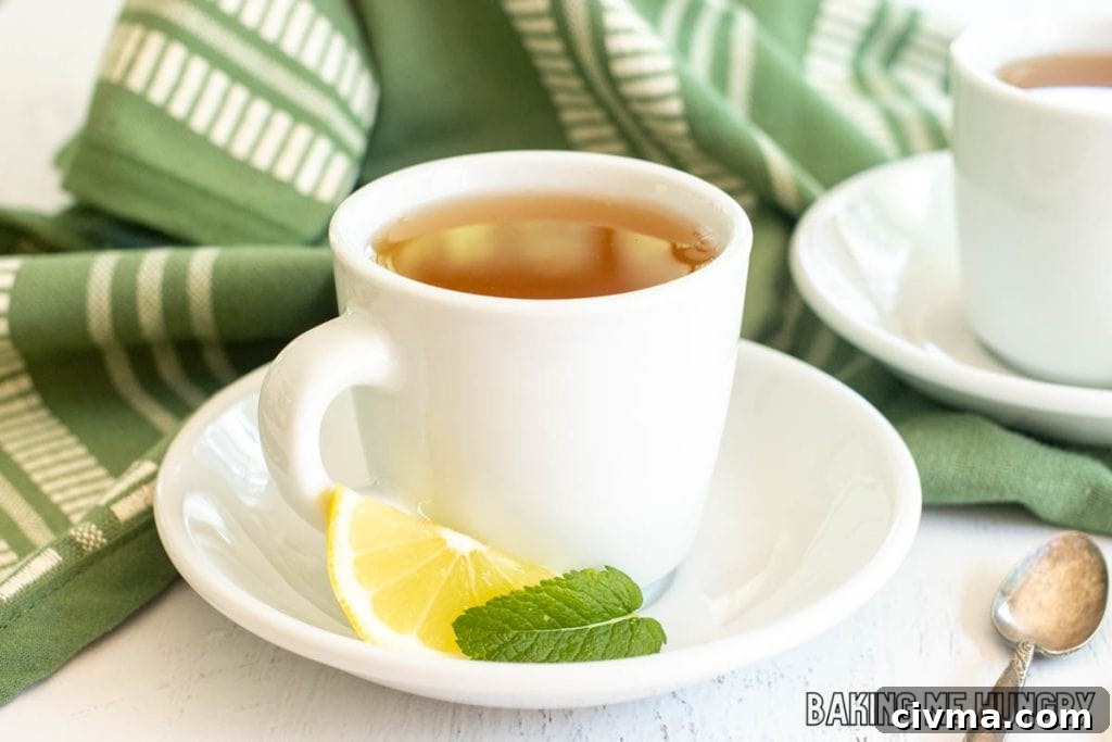 honey citrus mint tea recipe in white porcelain tea cup on saucer