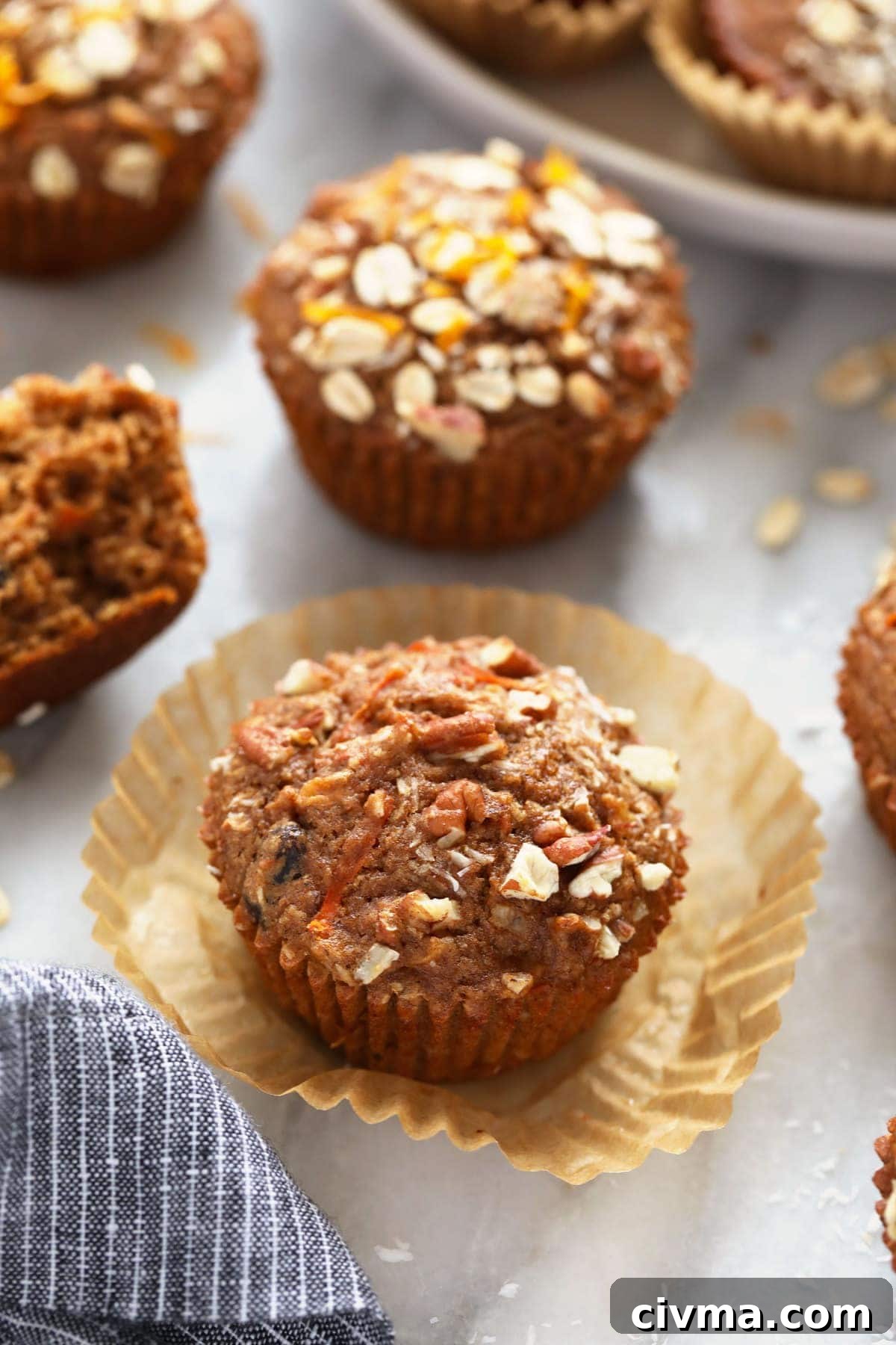 A morning glory muffin with fresh oats on top. 