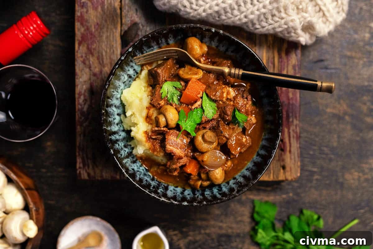 Beef Bourguignon served over mashed potatoes in a bowl