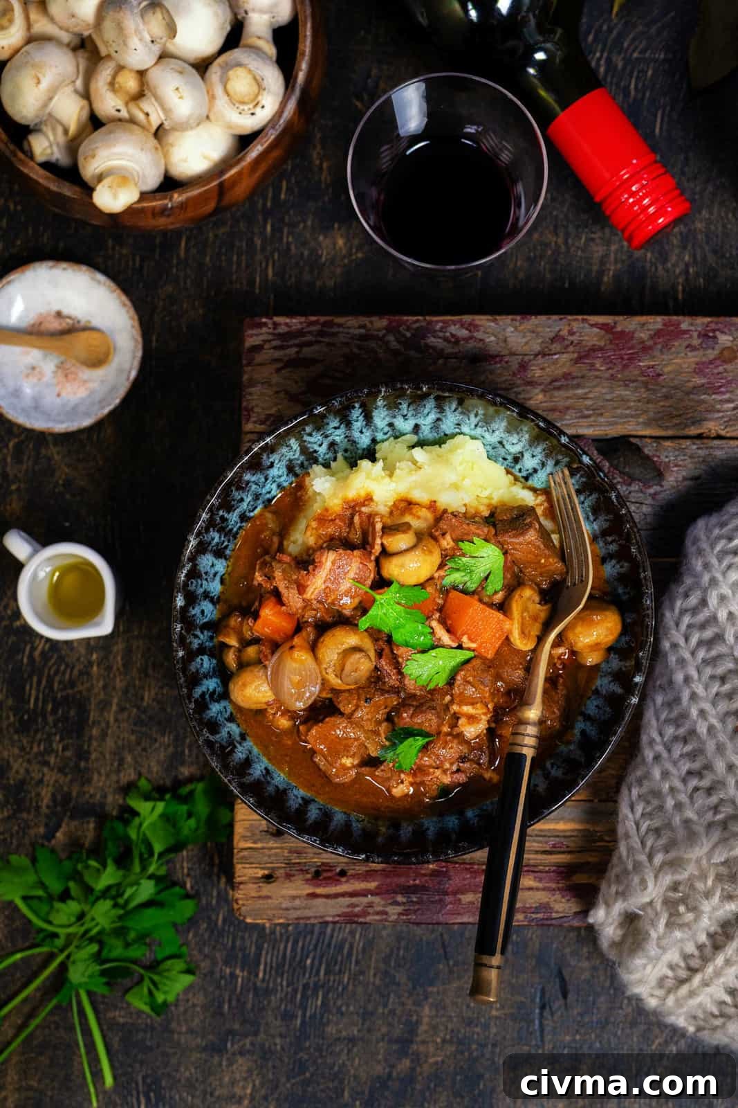 Beef Bourguignon served over mashed potatoes in a bowl