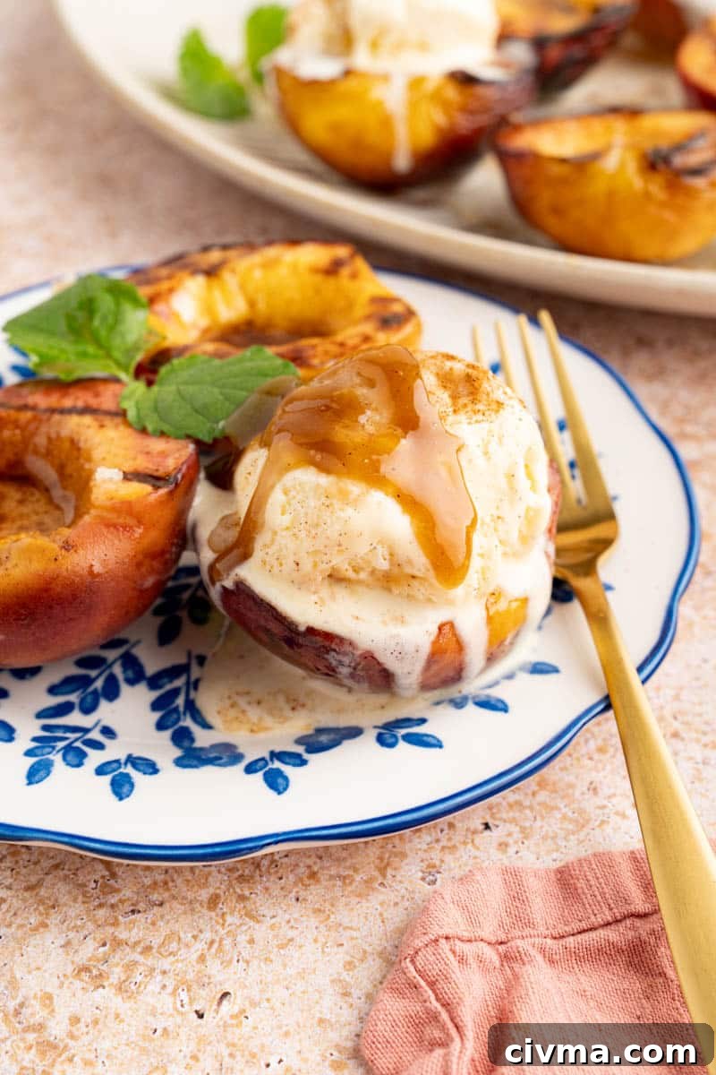 grilled peaches with ice cream on a plate with a fork to the side for serving