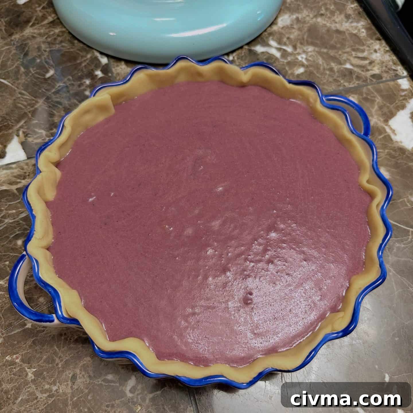 Unbaked purple sweet potato pie filling poured into crust—before baking step in Black folks’ soul food pie recipe by The Soul Food Pot®