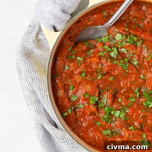 Homemade spaghetti sauce in a large yellow pot.