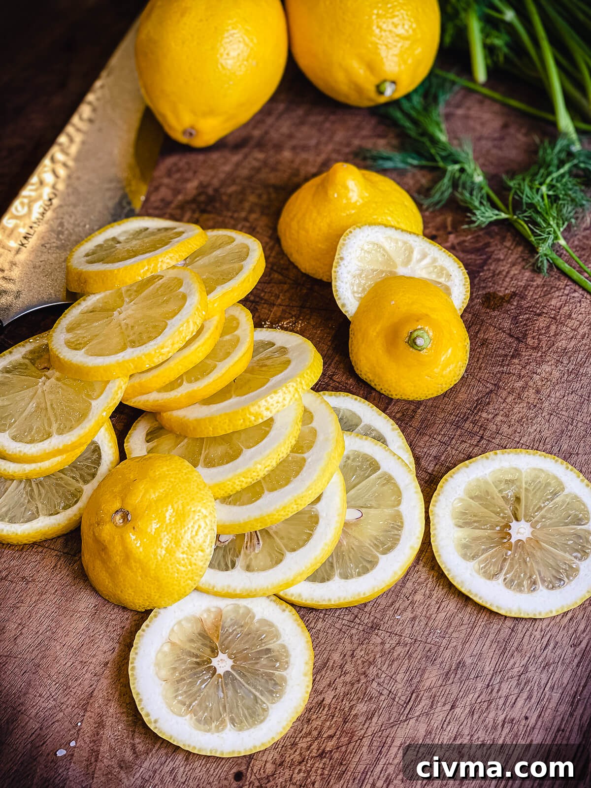 pile of sliced lemons on a cutting board