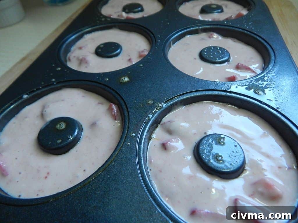 Strawberry donut batter in a donut pan