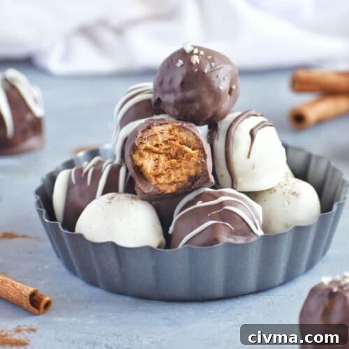 cake balls stacked in a grey tin, one with bite out of it.