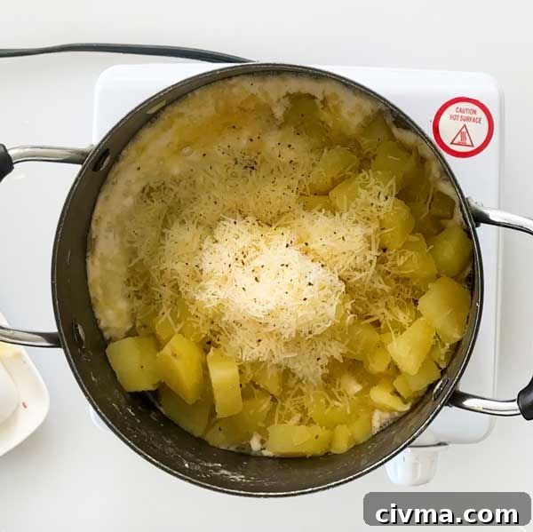 Creamy Garlic Cottage Cheese Mashed Potatoes 15 Adding the cheese and cream mixture to the steamed potatoes in a sauce pan.