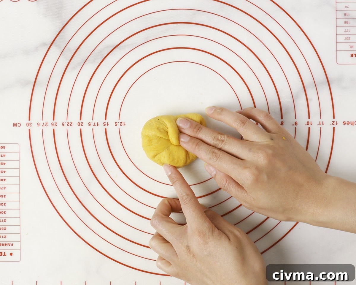 Soft Pumpkin Dinner Rolls Recipe 14 Shaping pumpkin dinner roll dough.
