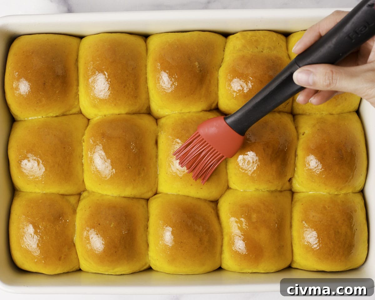 Soft Pumpkin Dinner Rolls Recipe 21 Pumpkin dinner rolls brushed with melted butter.