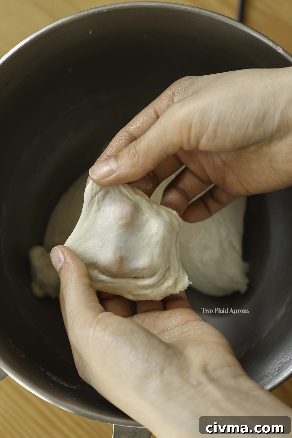 Soft Pumpkin Dinner Rolls Recipe 8 Showing the window pane stage of dough.