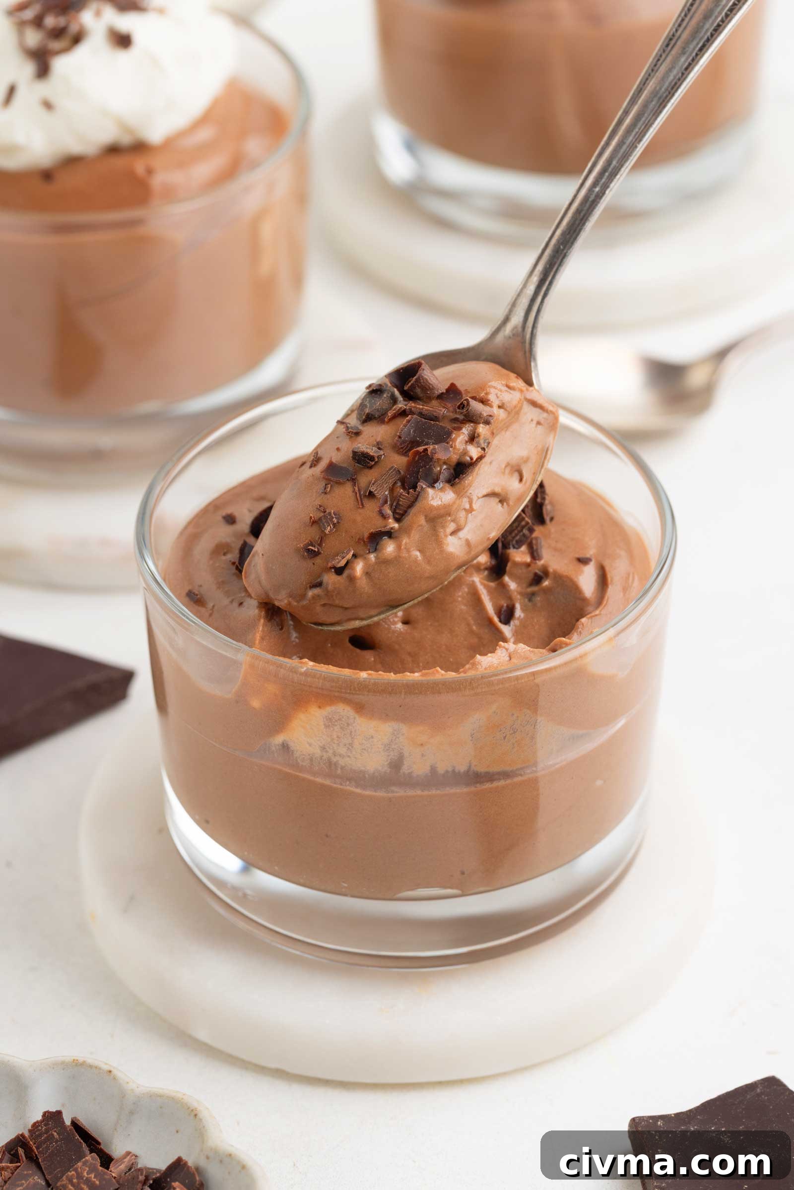 spoon digging into a glass of chocolate cheesecake mousse