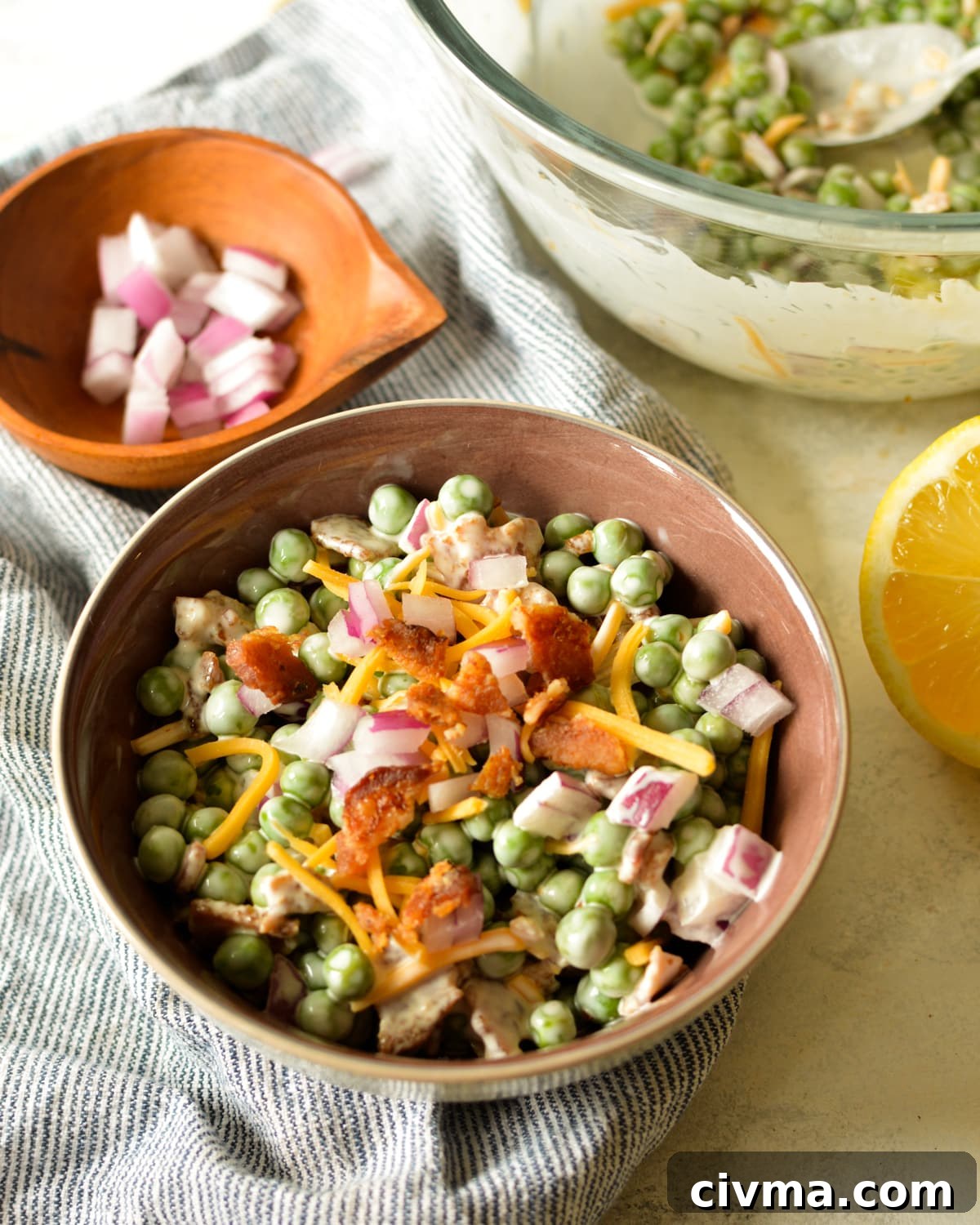 a bowl of english pea salad with bacon and cheese