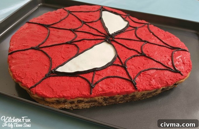 Decorating Spider-Man Cookie Cake with icing