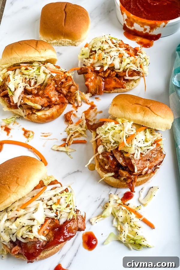 A platter of barbecue pork sliders with cole slaw.