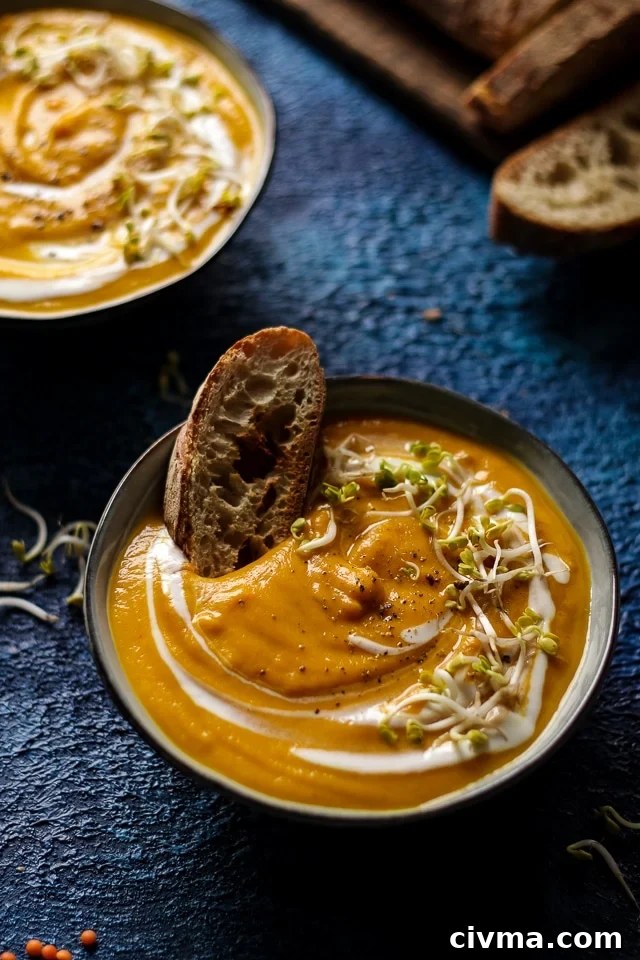 A Bowl of Sweet Potato Lentil Soup with a Slice of Crusty Bread