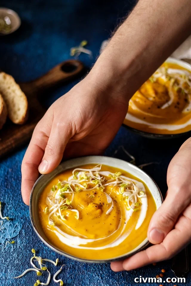 Hands Holding a Bowl of Vegan Sweet Potato Soup