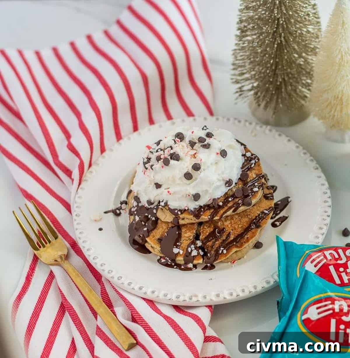 Christmas pancakes on a white plate with red and white towel