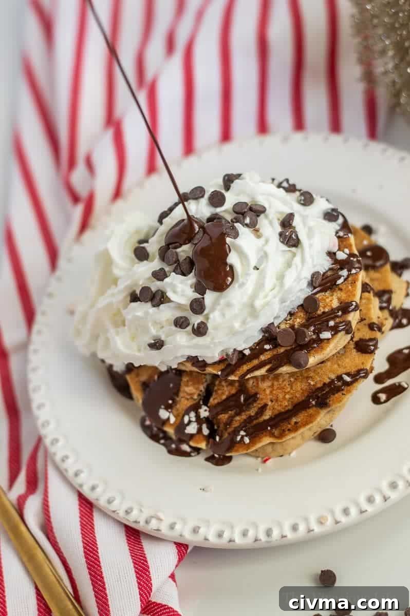 Christmas pancakes with chocolate drizzle being poured on