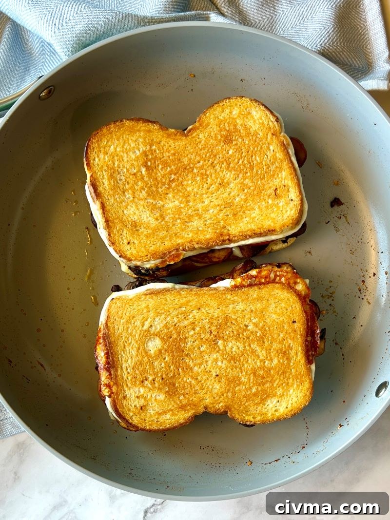 mushroom grilled cheese sandwich toasted in a skillet. 