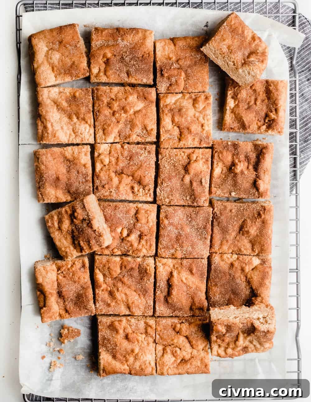 Snickerdoodle blondies scattered on a cooling rack