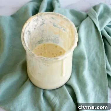 How to Reduce Sourness in Sourdough Bread 10 A jar of sourdough discard on a kitchen towel.