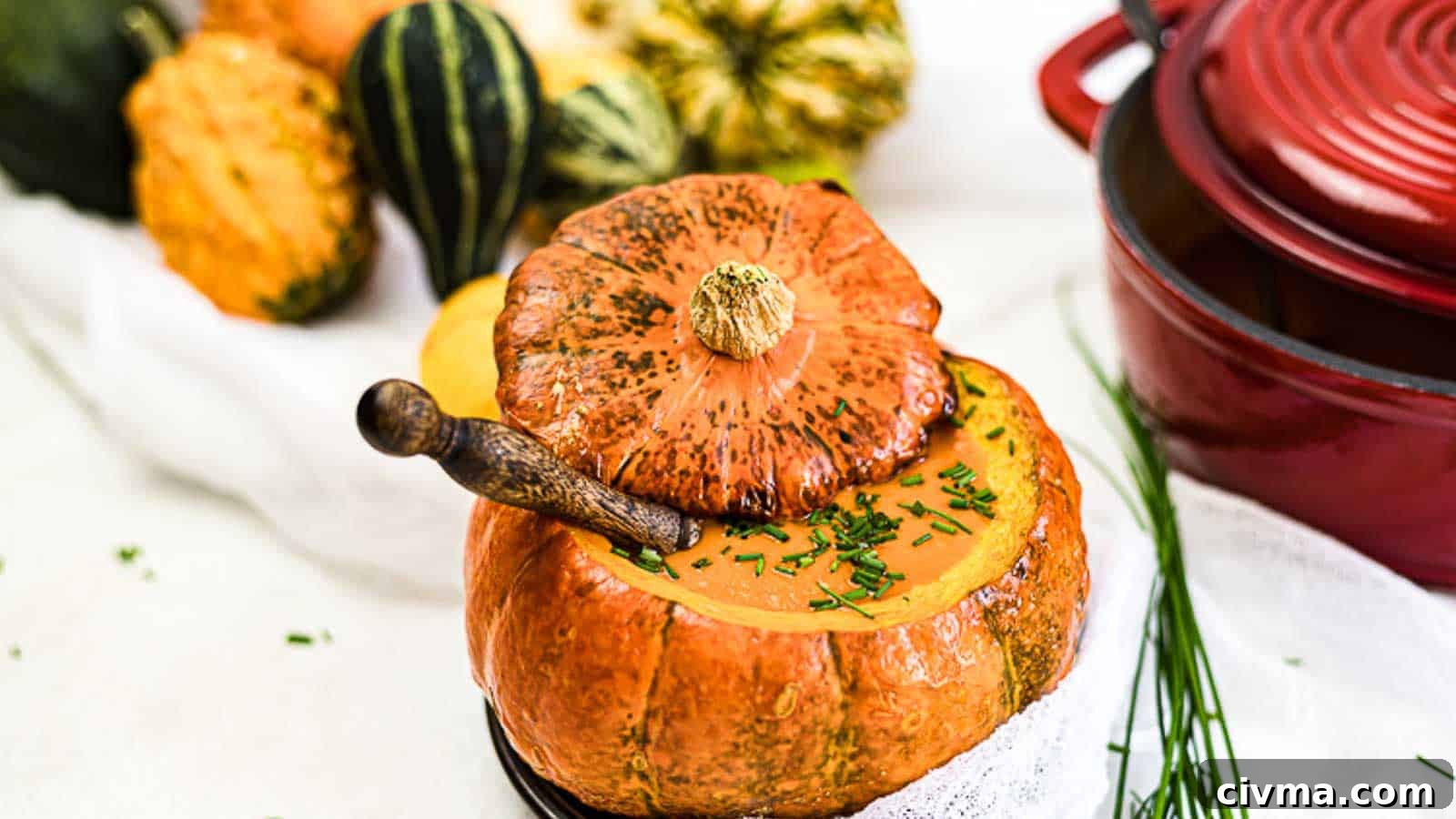 Creamy Roasted Pumpkin Soup inside baked pumpkin bowl.