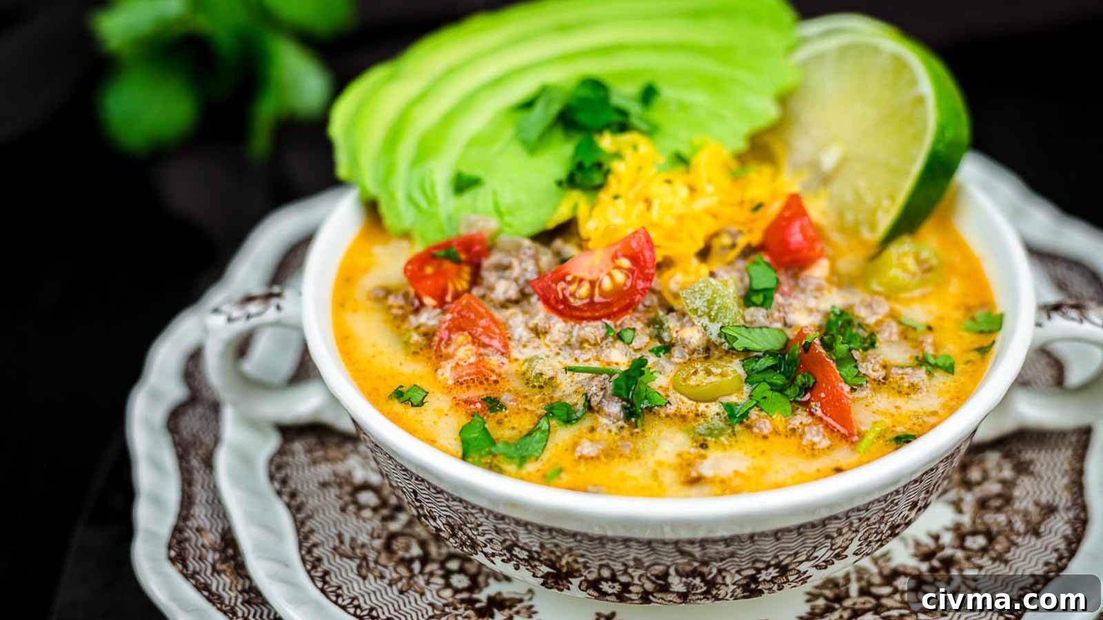 Creamy Keto Taco Soup with gresh avocado slices and lime.