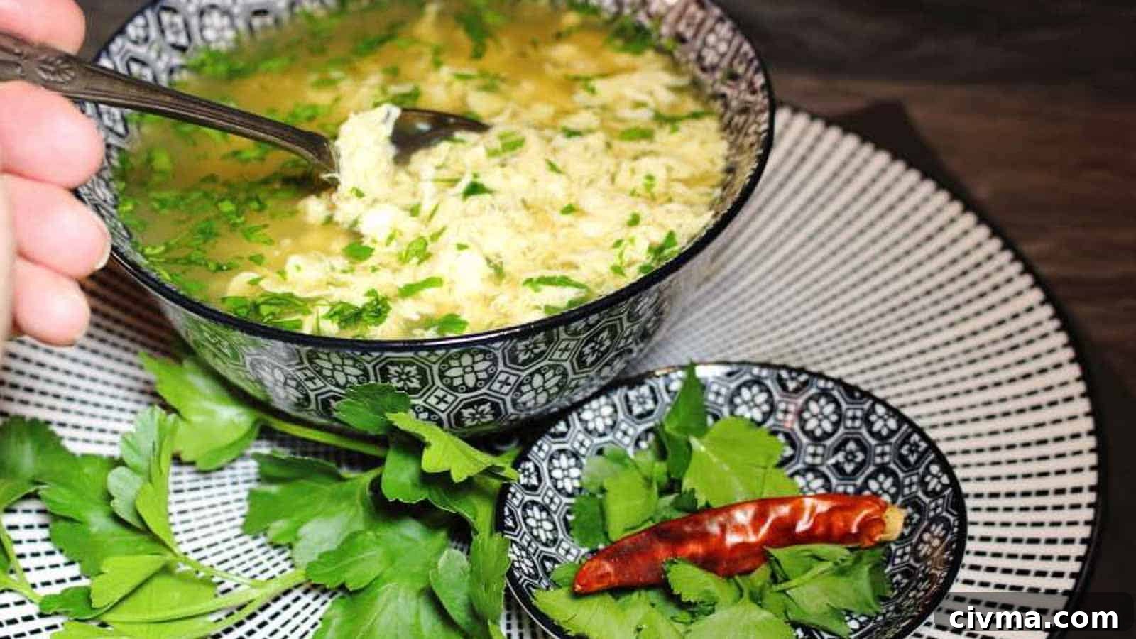 Egg Drop Soup inside blue bowl with spoon.