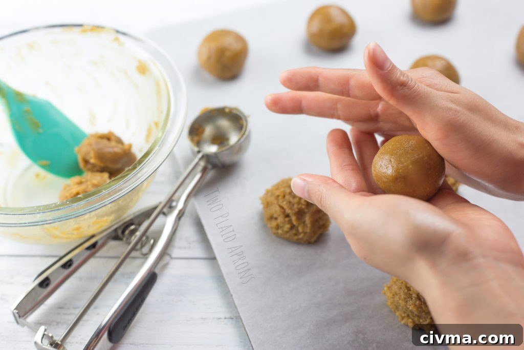 Gluten-Free Chewy Peanut Butter Cookies Recipe 3 Gluten free peanut butter cookie dough being rolled into balls.