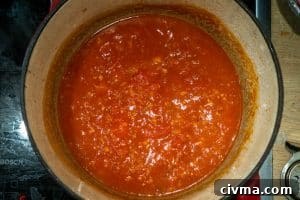 Adding the tomatoes to the pot