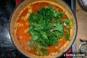 Adding the pasta and kale to the pot