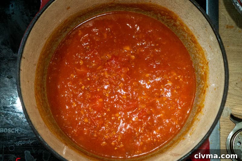 Adding the tomatoes to the pot