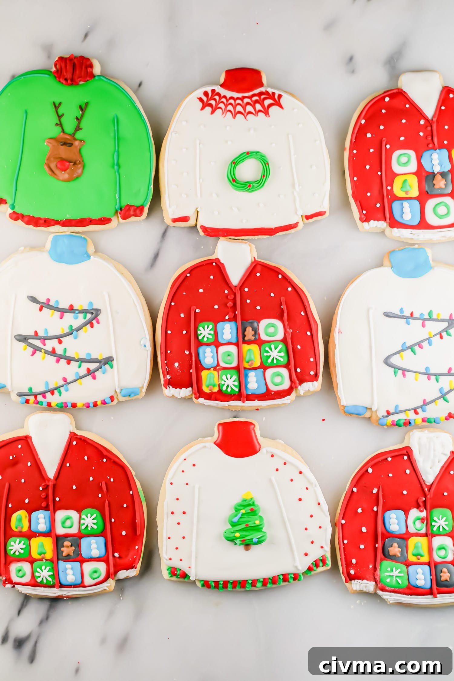 An overhead photo of rows of ugly sweater sugar cookies decorated with royal icing.