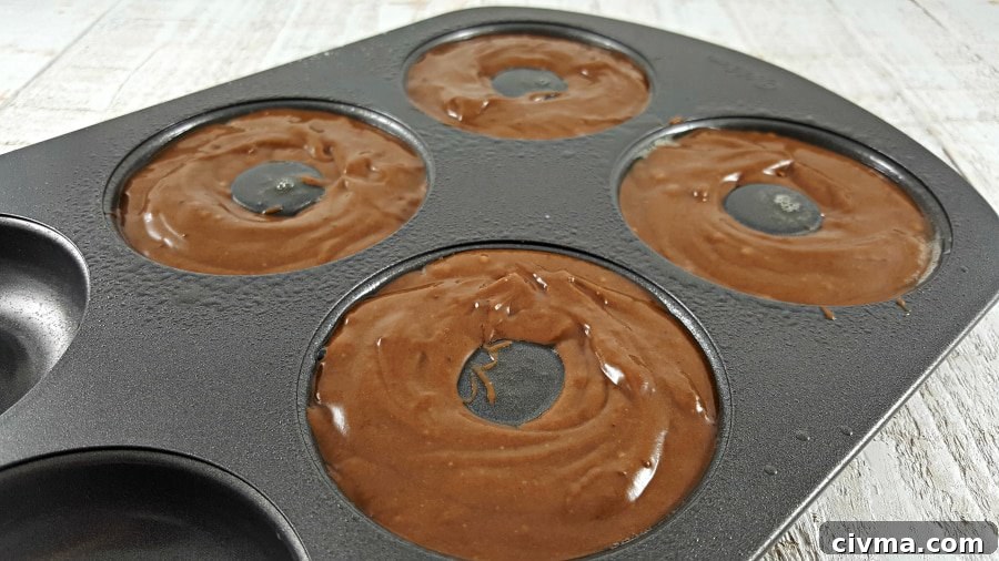 chocolate batter in a donut pan ready to bake.