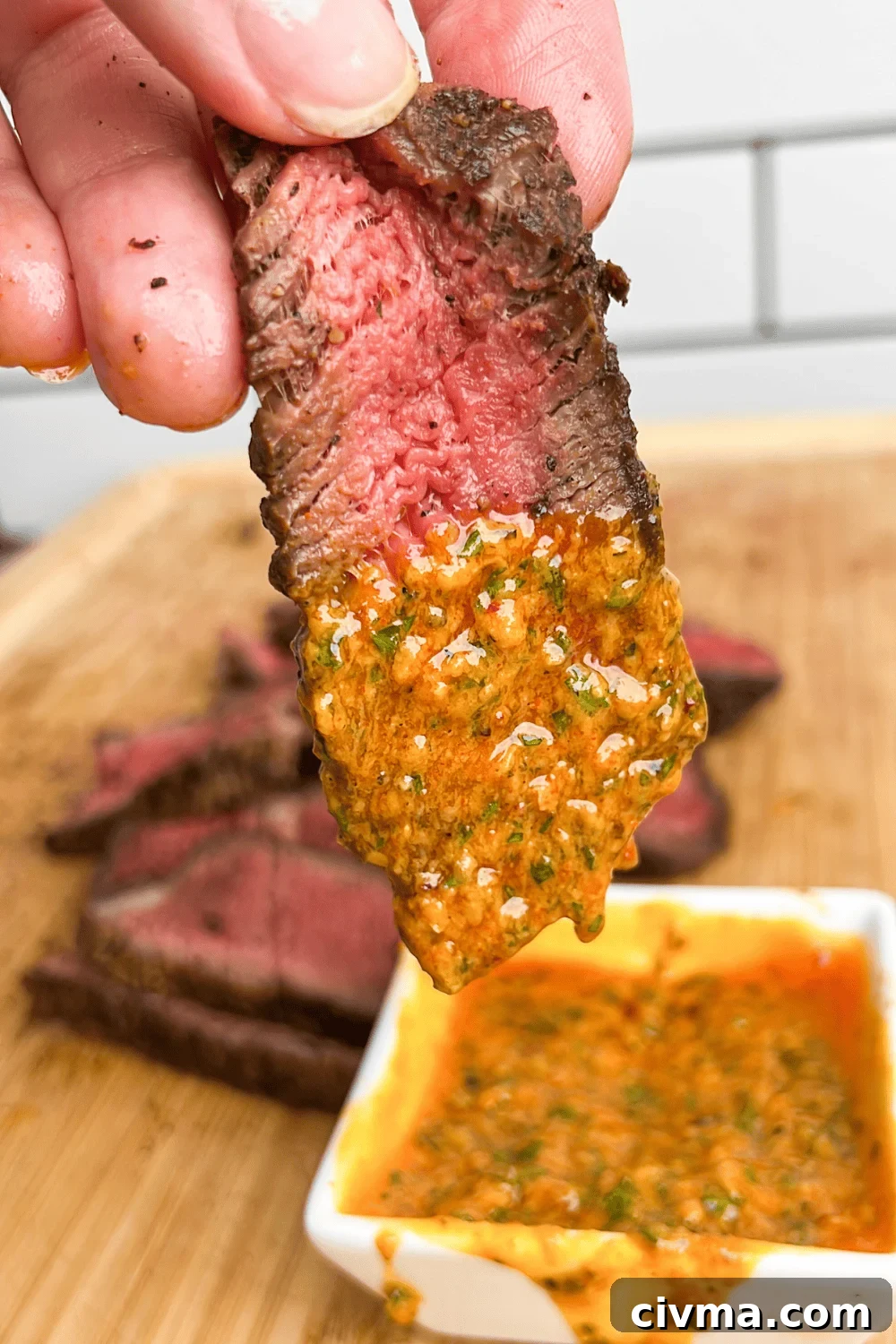 slice of steak dipping into cowboy butter