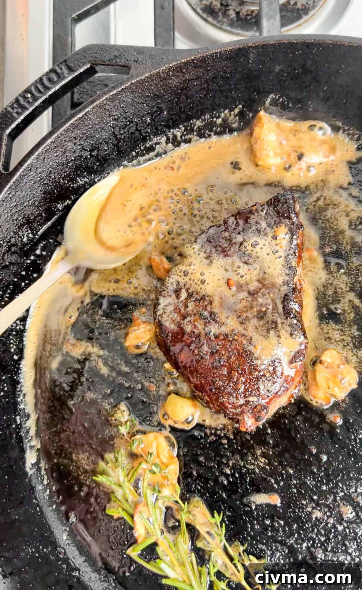 steak in a cast iron with butter