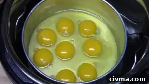 Eggs cracked into a pan for Instant Pot hard cooked eggs