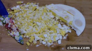 Cooked eggs released from the pan onto a cutting board