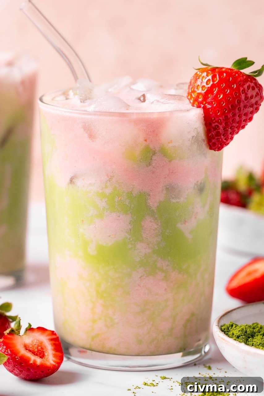 Iced Strawberry Matcha Latte Recipe 7 a matcha strawberry latte in a glass with ice.